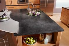 a kitchen with an island sink and stainless steel appliances