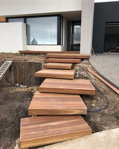 the steps are made out of wood in front of a house that is under construction