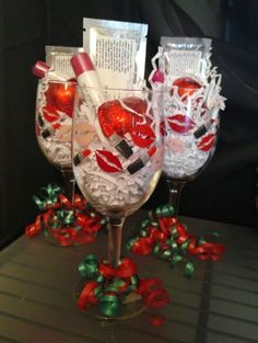 two wine glasses with red and white decorations on them, one is filled with confetti