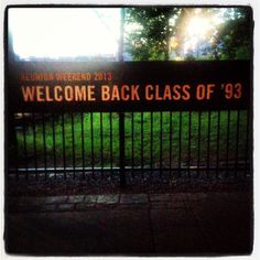 a welcome back class sign in front of a fence