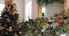 a christmas tree is decorated with greenery and other holiday decorations in front of a mirror