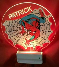 a lighted sign with a spiderman face on it's side and the words patrick above it