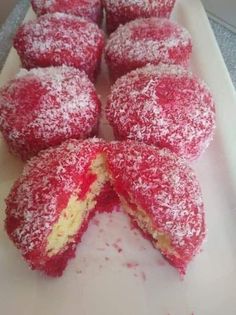 some powdered sugar covered pastries on a white tray