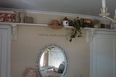 a mirror sitting on top of a white shelf