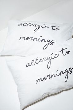 two pillows that have writing on them