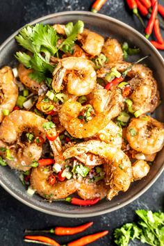 a bowl filled with shrimp and vegetables on top of a table