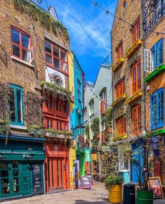 an alleyway with colorful buildings and potted plants