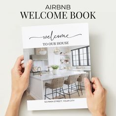 someone is holding up a welcome book for their new home in the kitchen and dining room