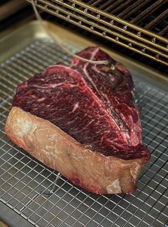 a piece of meat is on a rack in an oven