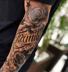 a man with a tattoo on his arm that says family and has roses in it