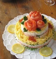 there is a cake with lemons and tomatoes on the top, sitting on a plate