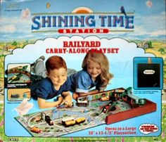 an advertisement for a toy train set with two children playing on the tracks and smiling at the camera