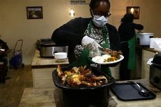 a woman wearing a face mask and gloves holding a plate of food