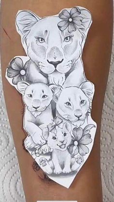 a woman's leg with tattoos on it and an image of two lions in the middle