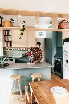 a man is in the kitchen preparing food