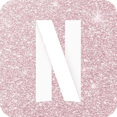 the letter n is made up of pink glitter and white paper on top of it