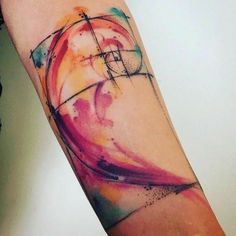 a person with a colorful tattoo on their arm that has an abstract design in the middle