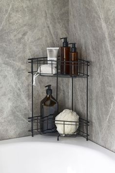 a bathtub with soap, shampoo and lotion bottles on the shelf next to it