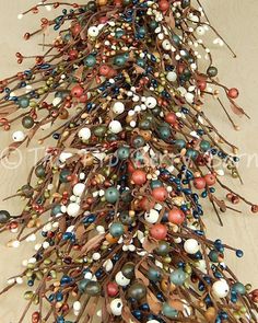 an arrangement of beads and twigs on a wooden surface with text overlay that reads, bead christmas tree