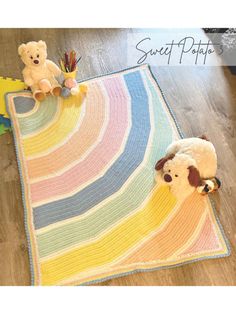 a crocheted rug with two stuffed animals on it and a teddy bear next to it