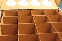 the inside of a cardboard box with several compartments and holes in each side that are open