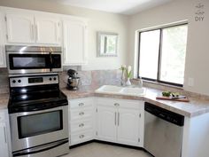 a kitchen with white cabinets and stainless steel appliances, including a dishwasher, stove, microwave, sink and window