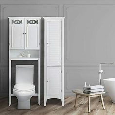 a white toilet sitting next to a bath tub in a bathroom with wooden floors and walls