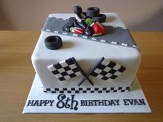 a birthday cake with a motorcyclist on the front and checkered design