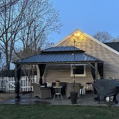 a house with a covered patio in the evening