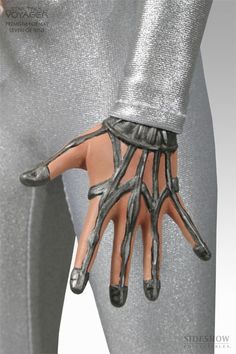 a person's hand is covered in silver fabric