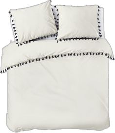 a bed with white sheets and black trimmings on the pillowcase is shown