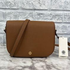 Brand New With The Tag Authentic Color Is Moose Brown Gold Tone Hardware Can Be Worn As Both A Crossbody And Shoulder Bag Saffiano Leather Interior Features Tory Burch Fabric Lining, 2 Slip Pocket, And 1 Zip Pocket When Used As A Single Strap, It Has Approximately 20” Drop When Used As A Double Strap, 10”Drop Approx: 8.5” L X 6.5” H X 2” D Same Or Next Day Shipping! Tan Crossbody Bag With Magnetic Closure, Tory Burch Crossbody Camera Bag, Tory Burch Emerson, Tory Burch Robinson Convertible Bag, Leather Crossbody Bag Tory Burch, Brown Crossbody Shoulder Bag With Gold-tone Hardware, Tory Burch Crossbody, Brown Crossbody, Tory Burch Bags