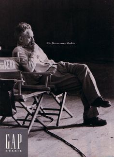 black and white photograph of man sitting in folding chair