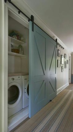 an open door in the middle of a hallway next to a washer and dryer