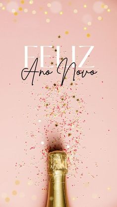 a bottle of champagne with the words feliz an nomos on it in front of a pink background