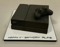 a birthday cake made to look like a video game console with the sony logo on it