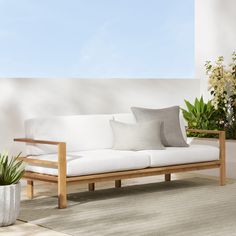 a white couch sitting on top of a wooden frame