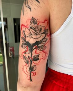 a woman with a rose tattoo on her arm