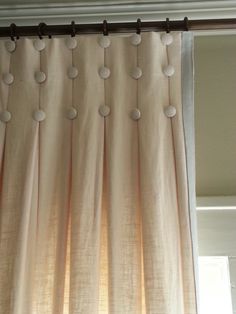 a curtain with white circles hanging from it's side