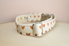 a white dog collar with hearts on it