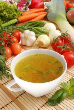 a white bowl filled with soup next to vegetables