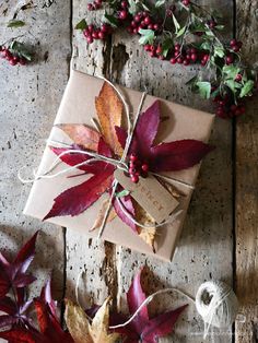 a gift wrapped in brown paper and tied with twine on top of a wooden table