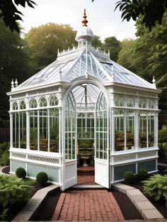 a large white glass house in the middle of a garden