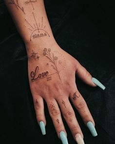 a woman's hand with tattoos on it and the word love written in cursive writing