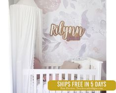 a baby's room with floral wallpaper and white crib in the foreground