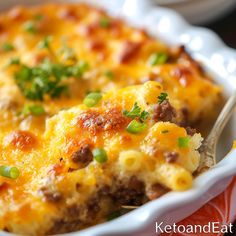 a close up of a casserole dish with meat, cheese and green onions