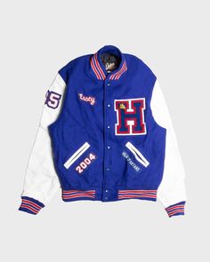 Get the preppy look with this cool varsity jacket. Sleeves are made of 100% leather in white and the main body is made from a warm blend of mixed materials in royal blue. Comes in a generous oversized fit, ideal for outdoor activities. Features classic red/blue striped collar, cuffs and waist, button up front, two white leather trimmed hand pockets. Features the words 'Steve's' across the back with the Spartans logo, 'Casey' on the right breast and a large 'H' on the left. Mint vintage condition Spartans Logo, Beige Jacket, Oversized Jumper, Preppy Look, Letterman Jacket, Grey Nikes, Fitted Trousers, Red Jacket, Oversized Fits