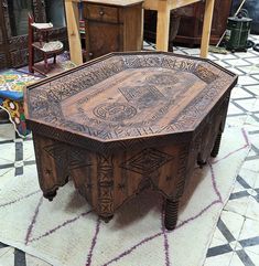 a wooden table sitting on top of a tiled floor