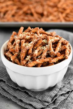 a white bowl filled with pretzels on top of a table