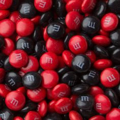 red and black m & m candies with white letters